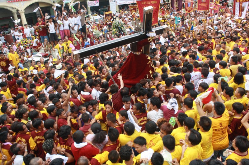A statue of Christ on the cross is carried through the streets of Manila during the Black Nazarene Festival (Pista ng Itim na Nazareno). The Philippines is one of only two predominantly Catholic countries in Asia. Photo by Denvie Balidoy (CC BY 2.0)