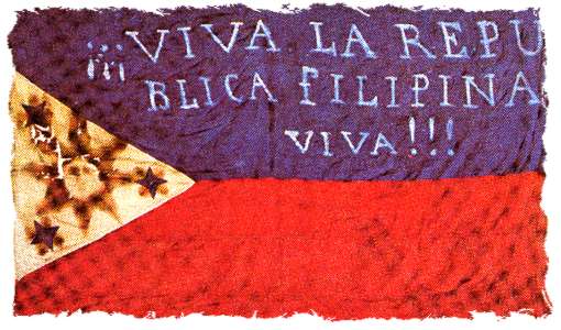Early flag of the Filipino revolutionaries ("Long live the Philippine Republic!"). The first two constitutions were written in Spanish. Photo: "Bandera 03". Licensed under Public Domain via Wikimedia Commons .
